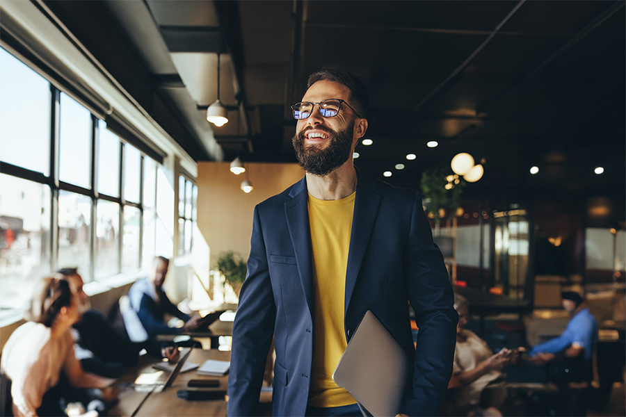 A smiling business person in a co-working space