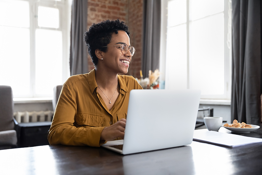 Happy worker completing the onboarding process on a laptop computer