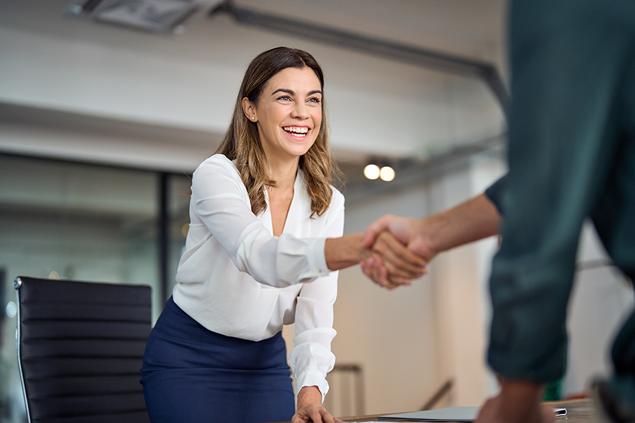 A happy business person shaking hands with a client