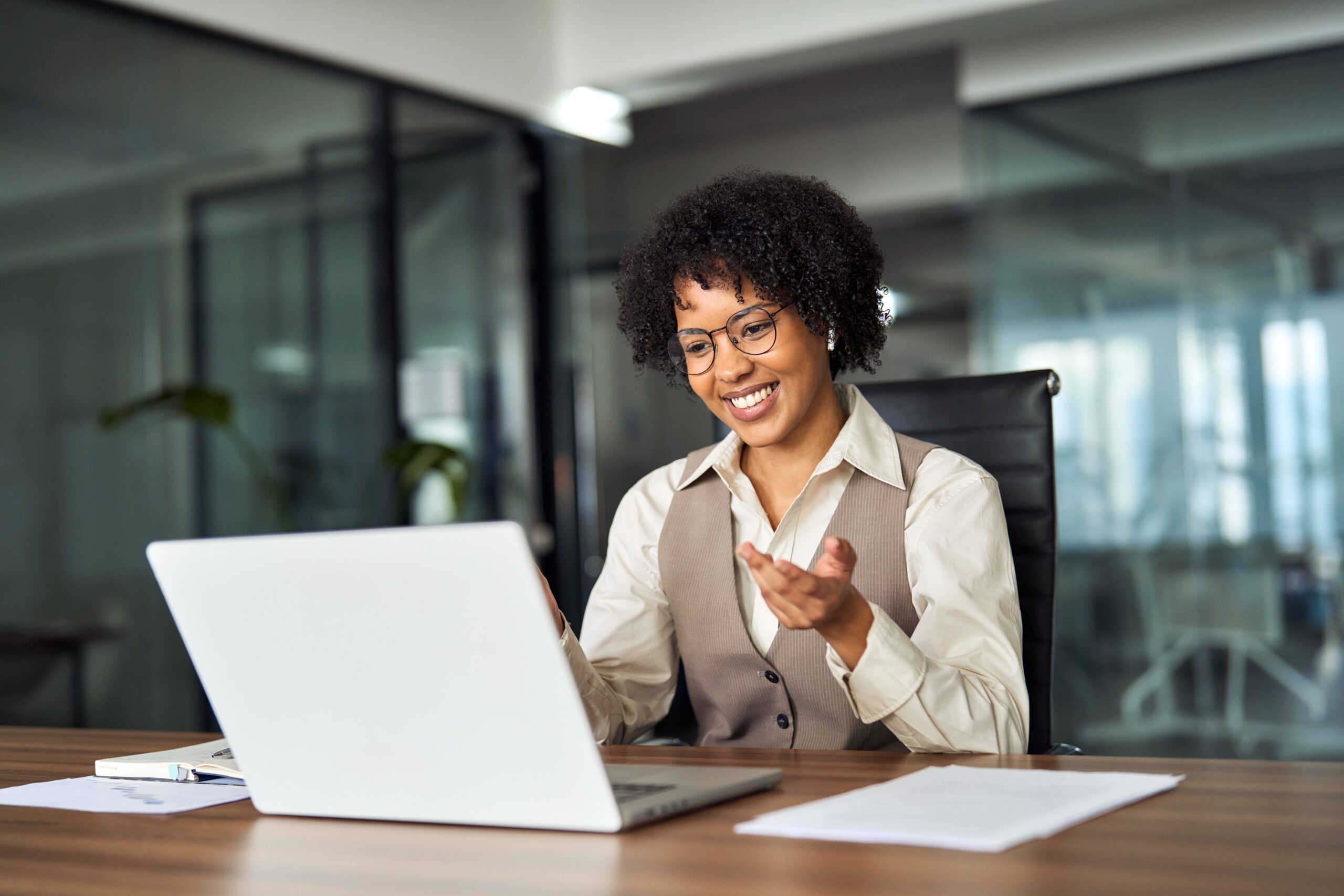 A young smiling professional using a laptop computer
